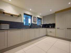 A kitchen with cabinets, sink, and appliances at Riverside Park 1 in Keswick