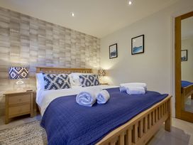A bedroom with a bed and bedside table at Riverside Park 1 in Keswick