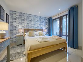 A bedroom with a bed and nightstand at Riverside Park 1 in Keswick