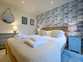 A bedroom with a bed, towels, and a lamp at Riverside Park 1 in Keswick