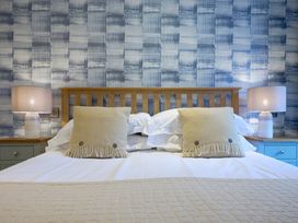 A bedroom with a bed and pillows at Riverside Park 1 in Keswick