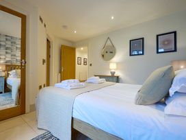 A bedroom with a bed and lamp at Riverside Park 1 in Keswick