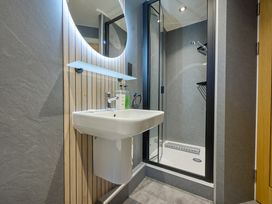 A bathroom with a sink and shower at Riverside Park 1 in Keswick