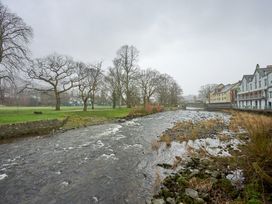 A river with trees and buildings alongside at Riverside Park 1 in Keswick