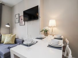 A living room with a dining table and sofa at 24 Baxtergate in Whitby