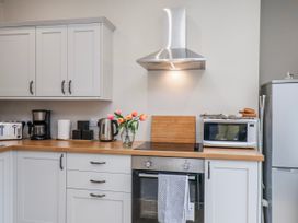 A kitchen with cabinets and appliances at 24 Baxtergate Whitby
