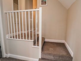 A staircase with white railing at 24 Baxtergate Whitby