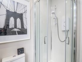 A bathroom featuring a shower and toilet at 24 Baxtergate, Whitby