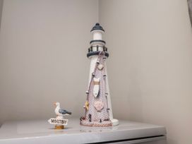 A lighthouse decoration and seagull figurine at 24 Baxtergate, Whitby