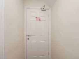 A door with a sign in a hallway at 24 Baxtergate in Whitby