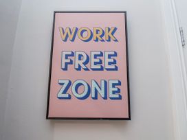 A framed wall art with the text 'WORK FREE ZONE'
