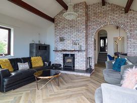 A living room with a sofa and a fireplace at Ser a Mor (Stars and Sea) Bull Bay near Amlwch