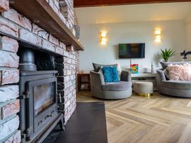 A living room with a fireplace and television at Ser a Mor (Stars and Sea) Bull Bay near Amlwch
