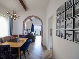 A dining room with a table and chairs at Ser a Mor (Stars and Sea) Bull Bay near Amlwch