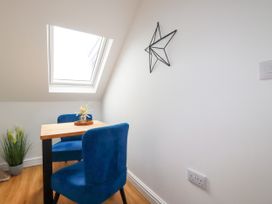 A dining area with a table and chairs at 5 St Gwithian Apartments