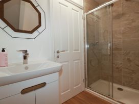 A bathroom with a wash basin and shower at 5 St Gwithian Apartments