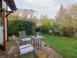 An outdoor seating area with table and chairs at Low Dow Crag in Coniston