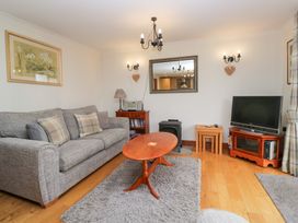 A living room with a sofa and a television at Low Dow Crag in Coniston