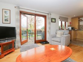 A living room with a television and an armchair at Low Dow Crag in Coniston