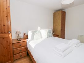 A bedroom with a bed and bedside lamp at Low Dow Crag in Coniston