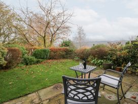 A garden with a table and chairs at Low Dow Crag in Coniston