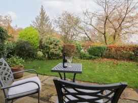 A garden with a table and chairs at Low Dow Crag in Coniston