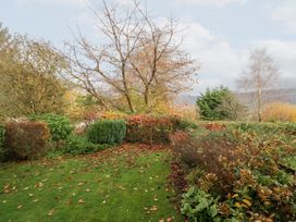 A garden with trees and fallen leaves at Low Dow Crag in Coniston