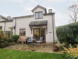 A house with patio furniture and garden plants at Low Dow Crag in Coniston