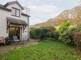 A garden with table and chairs outside at Low Dow Crag in Coniston