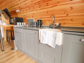 A kitchen counter with toaster kettle microwave sink and cups in a cabin at Mallard View in Cockerham near Lancaster