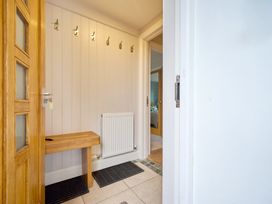 A hallway with hooks and a bench at Riverside Park 3 in Keswick
