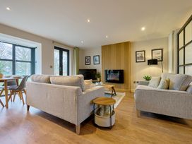 A living room with a sofa and table at Riverside Park 3 in Keswick