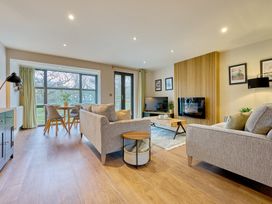 A living room with sofa and dining table at Riverside Park 3 in Keswick