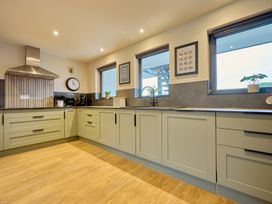 A kitchen with countertops and cabinets at Riverside Park 3 in Keswick