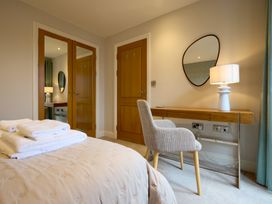 A bedroom with a bed and desk at Riverside Park 3 in Keswick