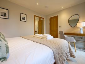 A bedroom with a bed and desk at Riverside Park 3 in Keswick