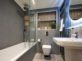 A bathroom with a bathtub, sink, and toilet at Riverside Park 3 in Keswick