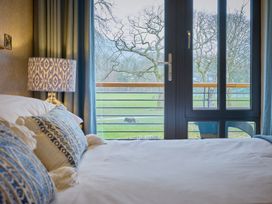 A bedroom with a bed and a view of the outdoors at Riverside Park 3 in Keswick