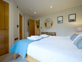 A bedroom with a bed and mirror at Riverside Park 3 in Keswick