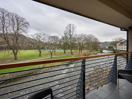 A balcony view of a river and trees at Riverside Park 5 in Keswick
