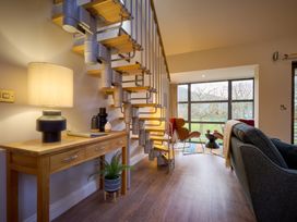 A living room with a staircase and seating area at Riverside Park 5 in Keswick