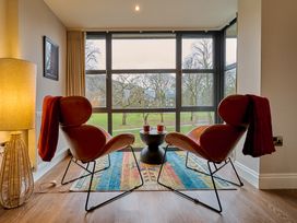 A living room with two chairs and a table at Riverside Park 5 Keswick