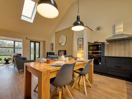 A kitchen with a dining table and chairs at Riverside Park 5 Keswick