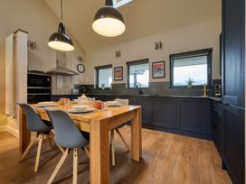 A kitchen with a dining table and chairs at Riverside Park 5 Keswick