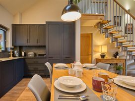 A kitchen with a dining table and chairs at Riverside Park 5 in Keswick