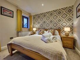 A bedroom with a bed and bedside tables at Riverside Park 5 in Keswick