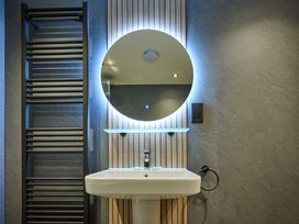 A bathroom with a mirror and sink at Riverside Park 5 in Keswick