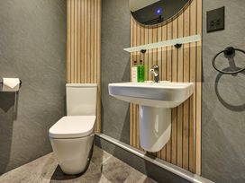 A bathroom with a sink, toilet, and a mirror at Riverside Park 5 in Keswick