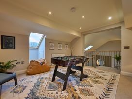 A game room with foosball table and sofa chair at Riverside Park 5 in Keswick