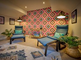 A snug with two recliners and a table at Riverside Park 5 in Keswick